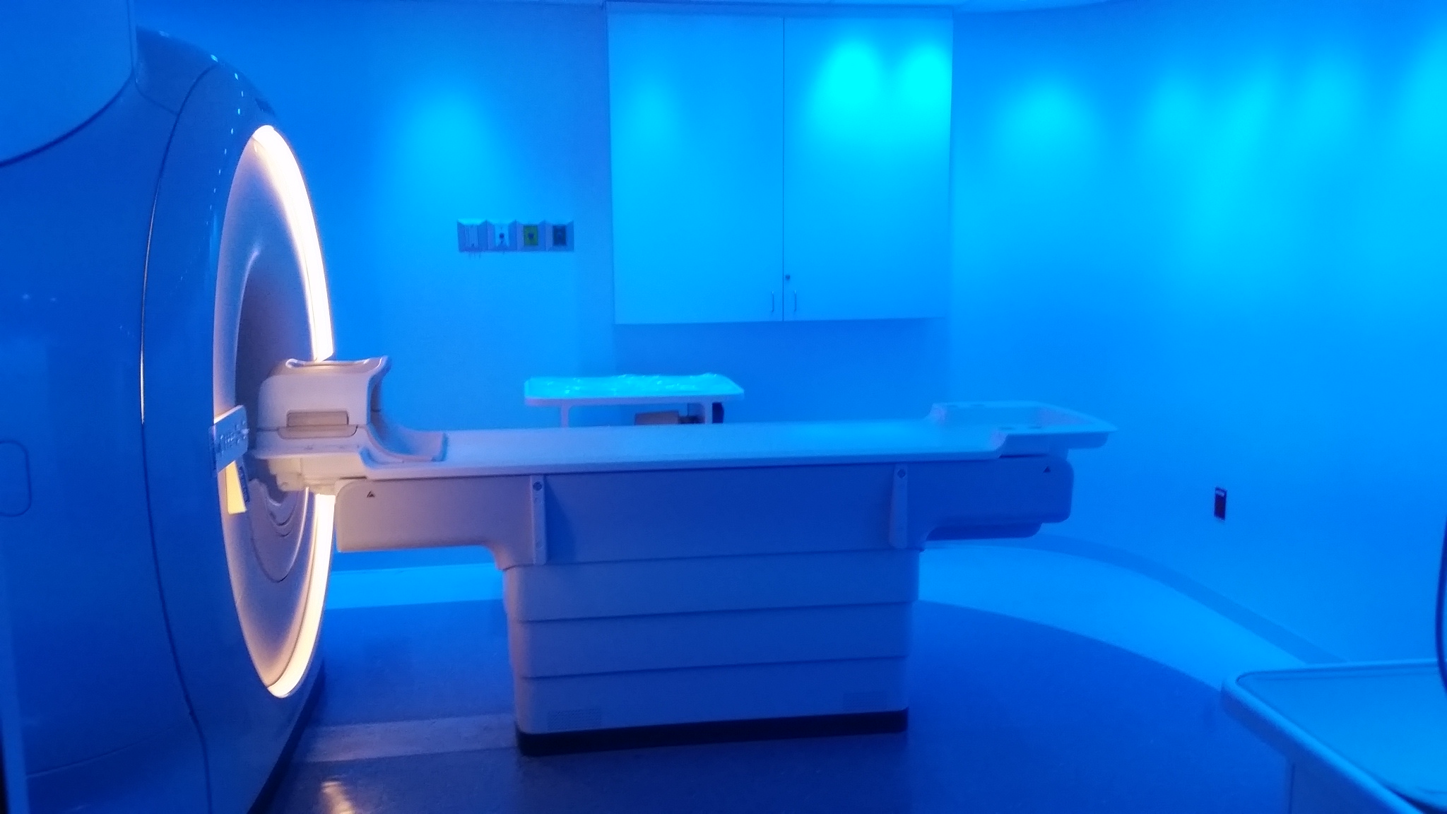 Blue-lit MRI suite with a Philips scanner
